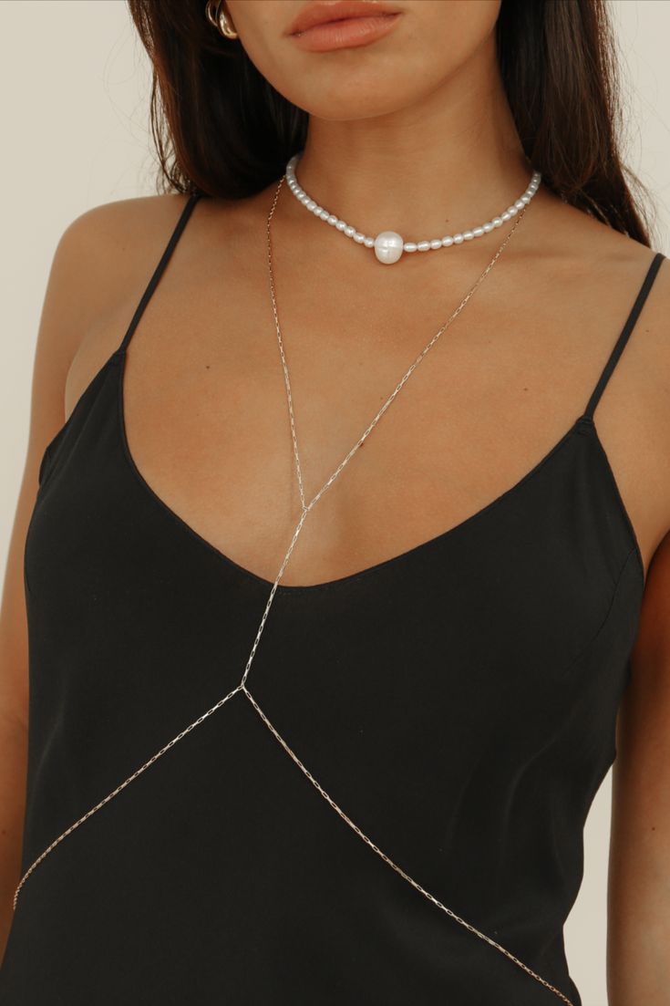 Our first ever body chain is here to stay, featuring an elongated flat box chain in 14k gold-filled. Created to delicately wrap you, this body chain is meticulously crafted with precision and care &  is the epitome of timeless luxury. Wear the Tara body chain all year round - over a slip dress, a bikini, with jeans or your favorite slip dress.

Chain Dimensions: 1.2mm flat box
Measurements: 23” Necklace & 30” Waist
Waterproof & tarnish resistant Elegant Beaded Pearl Chain Necklace, Rose Gold Jewelry With Gold Chain For Formal Occasions, Elegant Chain Jewelry For Parties, Formal Pearl Chain Necklace With Adjustable Chain, Elegant Chain Jewelry For Weddings, Elegant Party Jewelry With Chain Detail, Formal Lariat Chain Jewelry, Elegant Wedding Jewelry Chain, Elegant Adjustable Gold Chain Necklace