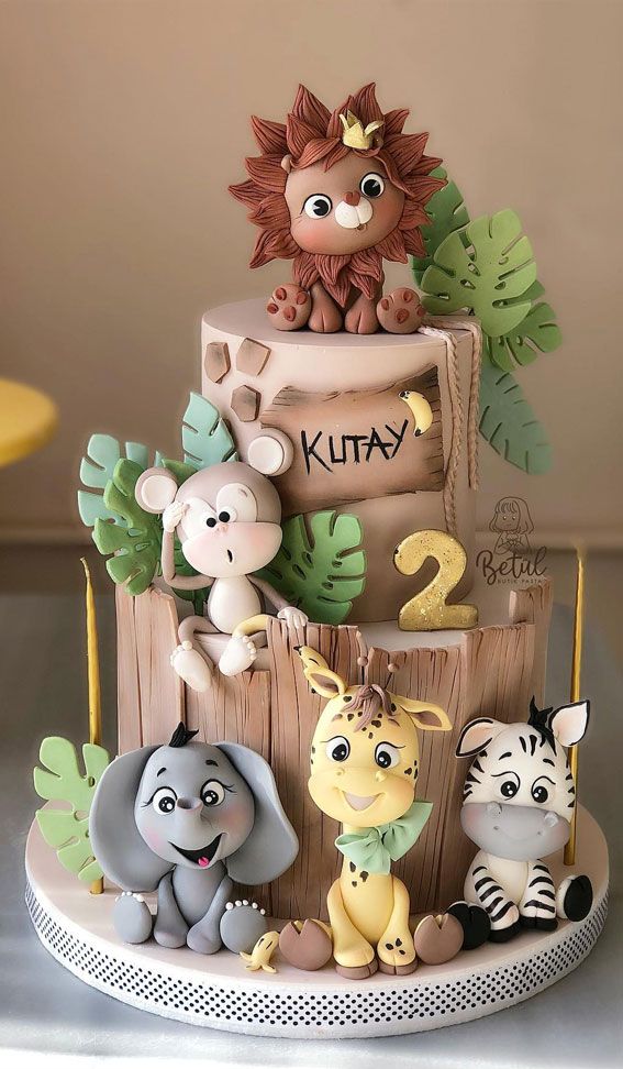 a three tiered cake with animals on it