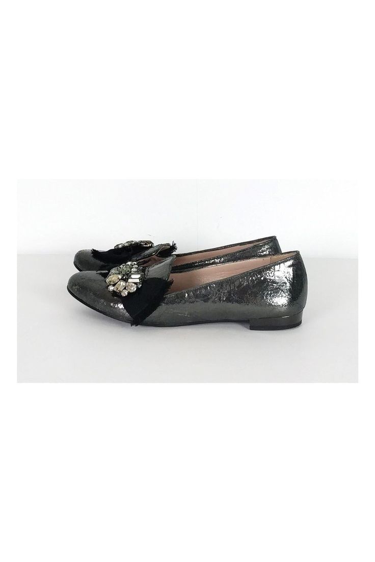 The leather of these flats has a unique crackled look. A bold rhinestone and ribbon design adorns the front. These luxe flats have all of the shimmer and glam you need. Size 6.5 (EU 36.5) Leather upper, lining & sole Made in Italy Rounded toe Crackled look to leather Rhinestone detail on front w/ ribbon Mirrored design on heel Light scuffs on toe Some outsole wear Outsole length 10" Silver Leather Party Flats, Party Patent Leather Slip-on Loafers, Slip-on Patent Leather Party Loafers, Glitter Round Toe Flats For Party, Glitter Flats With Round Toe For Party, Party Loafers With Rhinestones And Round Toe, Glitter Party Flats With Round Toe, Party Loafers With Almond Toe Slip-on, Slip-on Patent Leather Loafers For Party