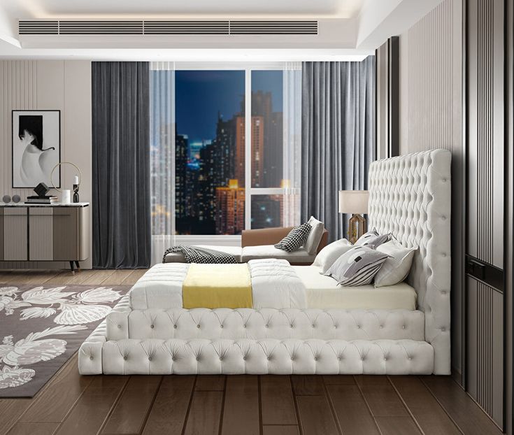 a bedroom with a large bed in front of a window and a cityscape on the wall