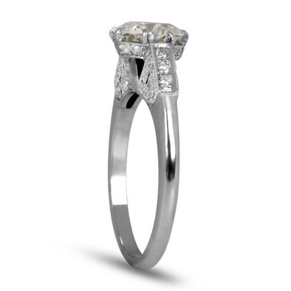 This platinum ring features a beautiful architectural design and sets a 1.39ct diamond cut in circa 1950. An additional .12 carats of diamonds flank the shoulders of the shank. ✦DIAMOND SPECIFICATIONS: Diamond Weight: 1.39 Carats Diamond Clarity: VS1 Clarity Diamond Color: H Color ✦ ENGAGEMENT RING SPECIFICATIONS: Ring Material: Platinum ✦ WHAT COMES IN YOUR SHIPMENT: - Your Engagement Ring - Quality Ring Box - Jewelry Cleaner - UGL Certificate ✦ WHY SHOP WITH US: - We've been in business for 40 Classic Gia Certified White Gold Cluster Ring, Gia Certified Diamond White Platinum Diamond Ring, Gia Certified Platinum Diamond Ring, Classic Gia Certified Platinum Ring, Timeless Gia Certified White Gold Diamond Ring, Luxury Marquise Cut Gia Certified Diamond Ring, Gia Certified Luxury Marquise Cut Diamond Ring, Gia Certified Marquise Cut Luxury Diamond Ring, Classic Gia Certified White Gold Rings