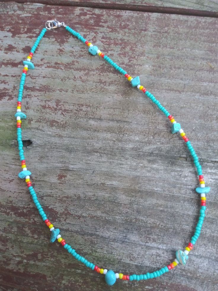 This necklace features turquoise stones and colorful western seed beads. Western Style Blue Necklace For Festival, Western Blue Jewelry For The Beach, Multicolor Beaded Turquoise Necklace For Festivals, Festival Turquoise Necklaces With Colorful Beads, Turquoise Beaded Hippie Necklace, Turquoise Hippie Beaded Necklace, Hippie Beaded Turquoise Jewelry, Bohemian Tiny Beads Turquoise Necklace For Beach, Festival Turquoise Necklace With Colorful Beads