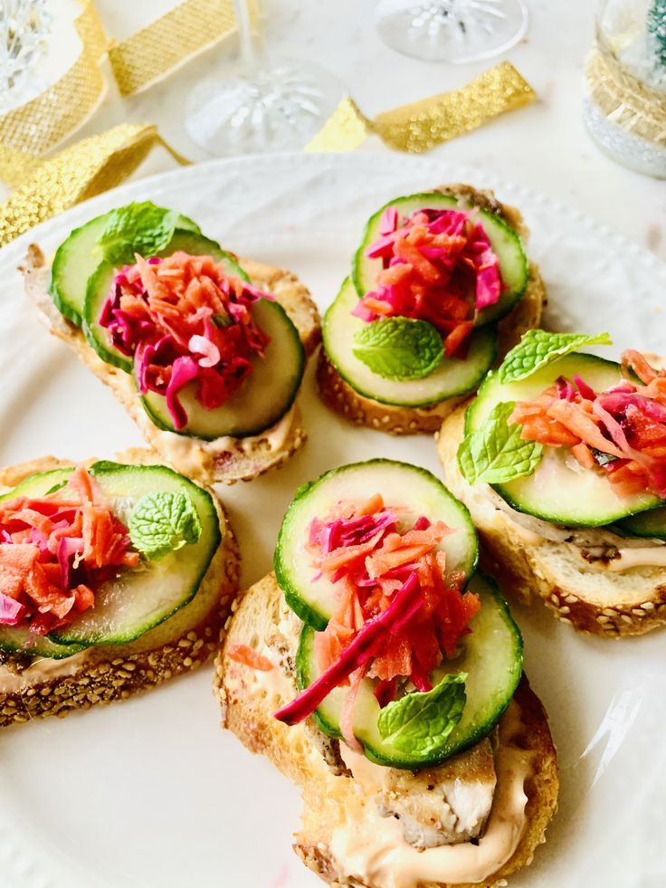 cucumber sandwiches are arranged on a white plate