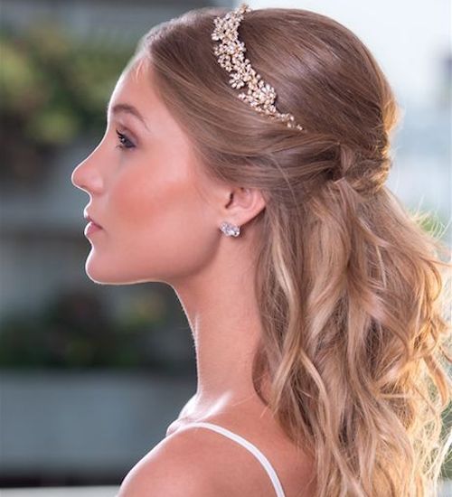 a woman with long blonde hair wearing a headpiece in the shape of a tiara