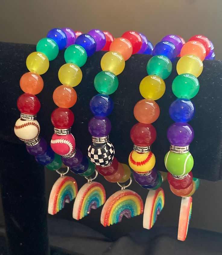 1 stretchy Bracelet with 2 sports beads and 1 charm. Color: Red, Orange, Yellow, Green, Blue, Purple  Size: approximately 7" Green Blue Purple, Red Orange Yellow, Palm Beach Fl, Stretchy Bracelets, West Palm Beach, West Palm, Acrylic Beads, Orange Yellow, Palm Beach