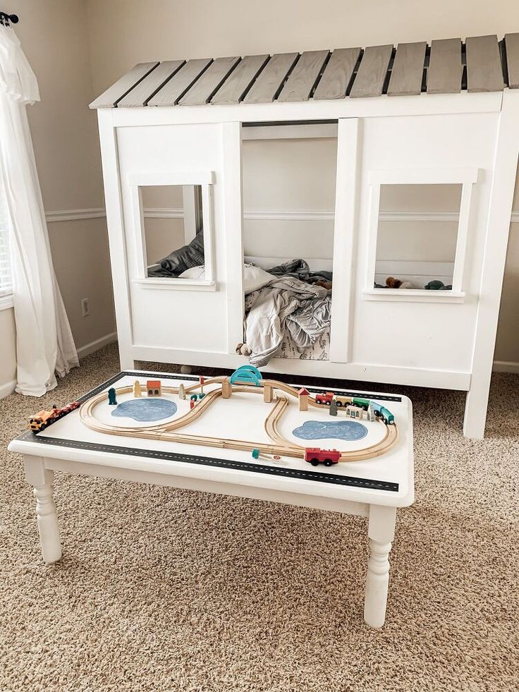 a child's train table in the middle of a room