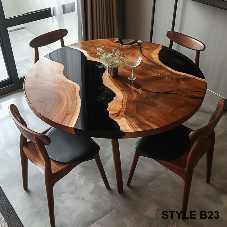 a wooden table with two chairs and a wine glass on it in front of a window