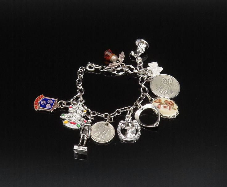 925 Silver - Vintage Enamel Christmas Tree, Coin & Multi Charm Bracelet - BT9735  Jewelry Type:          Bracelet  Metal Type:             925 Silver  Metal Size:              7" Length x 1"   Stone Type:             N/A    Condition:               N/A  Jewelry Weight:      22.2 Grams   PLEASE NOTE: THIS ITEM IS PRE-OWNED. ALTHOUGH MOST ITEMS ARE IN VERY GOOD CONDITION, SOME MAY NEED CLEANING AND/OR MINOR REPAIRS. WE MAKE A VERY STRONG EFFORT TO UPLOAD CLEAR PICTURES. PLEASE INSPECT ALL PICTURES AND ASK ALL QUESTIONS YOU MAY HAVE PRIOR TO MAKING A PURCHASE. NOT ALL STONES ARE GENUINE, SOME ARE ENHANCED OR CREATED. Collectible Silver Christmas Jewelry, Silver Hallmark Jewelry For Christmas, Christmas Silver Hallmark Jewelry, Silver Christmas Charm Bracelet Gift, Christmas Silver Charm Bracelet Gift, Silver Charm Bracelet For Christmas, Silver Charm Bracelet For Christmas Gift, Silver Charm Bracelets For Christmas, Clear Pictures