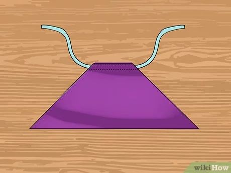 an upside down purple object sitting on top of a wooden table