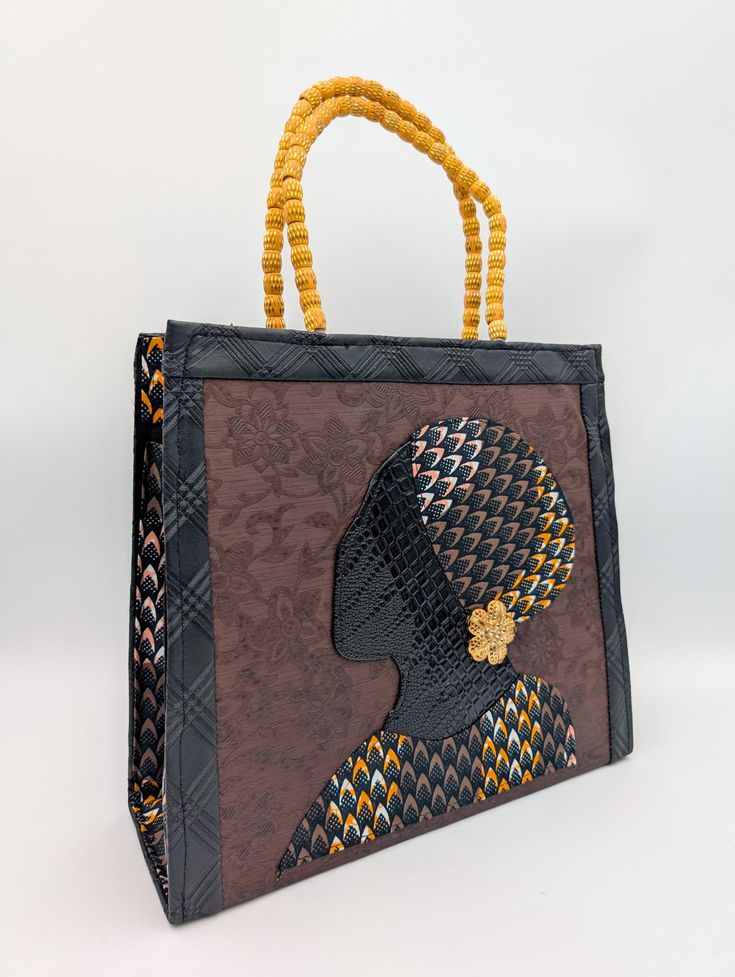 Stand out with our Handmade African Print Tote Bag! This striking Ankara handbag with the silhouette of a beautiful African queen combines tradition with modern style. It was handcrafted by skilled artisans in Ghana, West Africa, using authentic Ankara fabric. Perfect for the fashion-forward woman who values unique, high-quality craftsmanship. Detailed Product Description: * Handmade in Ghana by local artisans, from vibrant, durable Ankara fabric with a bold African print, and faux leather * Features sturdy handles and a spacious interior for all your daily essentials * Lightweight yet strong enough to carry heavier items * Designed with versatility for work, travel, or casual outings Usage and Benefits: * Everyday Use: A perfect tote for work, errands, or weekend getaways * Statement Acce Luxury Handwoven Bags For Gifts, Luxury Handmade Tote Box Bag, Black Handwoven Bags Suitable For Gifts, Handwoven Black Shoulder Bag As Gift, Handwoven Black Shoulder Bag For Gift, Handwoven Black Shoulder Bag Gift, Handmade Black Handheld Bag, Traditional Black Tote Bag, Artisan Black Bag For Daily Use