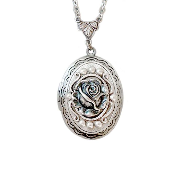 The antique style silver plated floral engraved locket is 30mmx25mm. The antique style silver rose the front of this locket. The locket is connected to a 24 inch chain by a rosary style connector. The little rose is vary detailed, The locket is oval in shape and has a lace filigree edging that frames the outside. The locket is packaged in a lovely little silhouette box, set on a soft piece of white cotton. ♥ * ♥ * ♥ * ♥ * ♥ * ♥ * ♥ * ♥ © Original design by Twilight's Castle Thank you for visitin Mother's Day Silver Locket Jewelry, Silver Locket Jewelry For Mother's Day, Vintage Rose Design Jewelry As A Gift, Rose Nickel Free Jewelry For Gift, Rose-colored Nickel-free Jewelry For Gifts, Rose Nickel-free Jewelry For Gift, Silver Round Pendant With Rose Design, Silver Necklace With Rose Design, Vintage Rose-colored Jewelry For Gifts