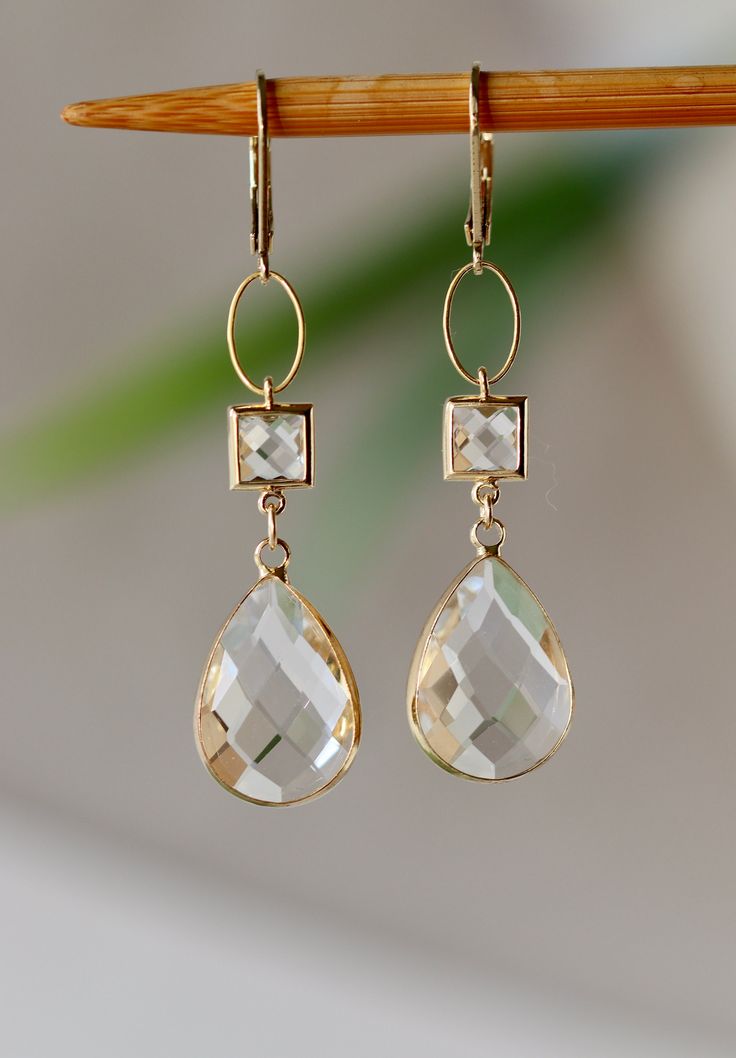 Beautiful, elegant Earrings with Clear Faceted Glass Square Connectors 7 x 7 mm Faceted Clear Glass Drops clear like drop of Water 17 x 11 mm. in Gold plated Bezel frame Gold plated Lever back Ear Clasp. The total length is 2.25 inches or 58 mm long.  Your order will be wrapped and shipped in jewelry gift box. * * * * * * * * * * * * * * * * * * * * * * * * * * * * * * * * * * * * * * * * * *  If you would like to order this item as a gift you can leave a personalized note for the receiver durin Cheap Clear Drop Earrings, Elegant Clear Earrings As Gift, Classic Crystal Earrings As A Gift, Elegant Hypoallergenic Crystal Earrings For Anniversary, Clear Round Wedding Earrings, Formal Clear Teardrop Earrings, Clear Dangle Earrings For Formal Occasions, Elegant Clear Crystal Earrings For Anniversary, Hypoallergenic Clear Jewelry For Wedding