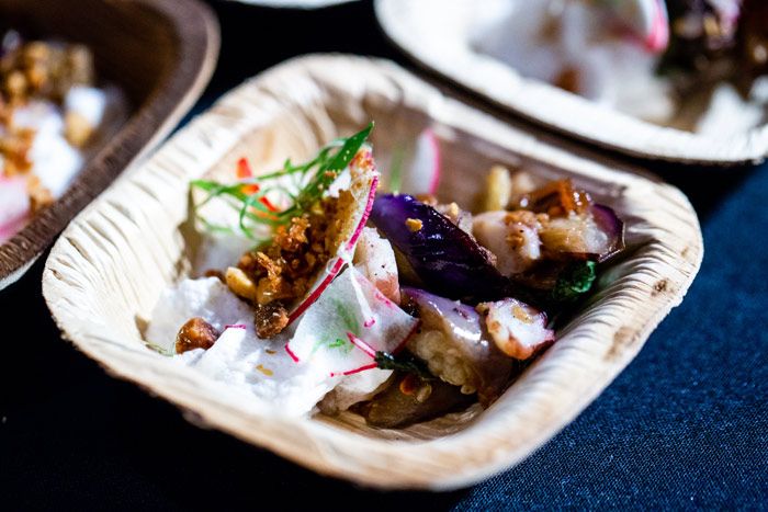 there are many different types of food in the paper plates on the table together,