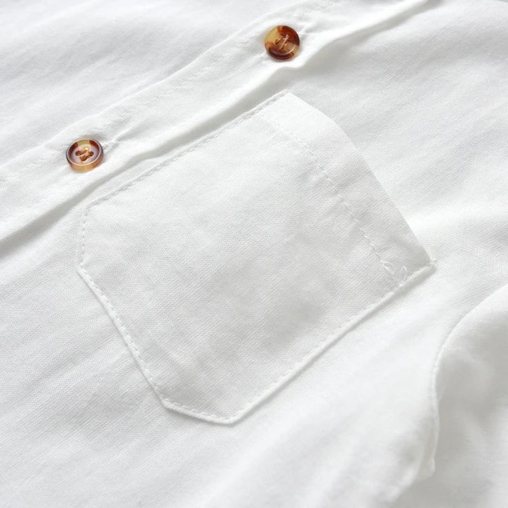 Upgrade your child's summer wardrobe with our 100% Cotton dress shirt, perfect for kids aged 1-6 years! Designed with attention to detail and crafted for comfort, this shirt will keep your little one looking sharp and feeling great all day long. With a classic button-front design and handy front pocket, it adds a touch of sophistication to any outfit. The lightweight cotton fabric is breathable and airy, perfect for warm summer days. The versatile white color allows for both casual and formal st White Summer Shirt With Pockets, White Summer Shirt With Button Closure, One Summer, Shirt Dress Casual, Spring Shirts, One Piece Dress, Front Design, Mandarin Collar, Feeling Great