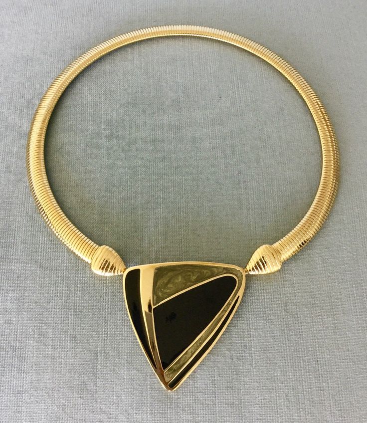 "You are looking at a truly exquisite VINTAGE TRIFARI MODERNIST, ART DECO STYLE, KUNIO MATSUMOTO ERA, BLACK and SILVER-COLOURED ENAMEL AND GOLD METAL OMEGA SNAKE CHAIN PENDANT COLLAR NECKLACE, SIGNED, Circa 1980's. THIS COLLAR NECKLACE IS EXTREMELY BOLD, EYE-CATCHING AND GORGEOUS SUPER RARE MINT, IN EXCELLENT, LIKE NEW CONDITION, IT HAS NEVER BEEN USED THIS NECKLACE WITH AN ART DECO INSPIRED BLACK AND SILVER ENAMEL STATION AND SUPER SHINY OMEGA CHAIN IS EXTRAORDINARILY BEAUTIFUL AND SCULPTURAL T Designer Yellow Gold Evening Necklace, Designer Yellow Gold Necklaces For Evening, Designer Yellow Gold Necklace For Evening, Designer Metal Necklaces For Formal Occasions, Vintage Black Enamel Necklaces For Evening, Vintage Black Enamel Necklace For Evening, Vintage Black Enamel Necklaces For Formal Occasions, Vintage Black Enamel Necklace For Formal Occasions, Vintage Jewelry With Unique Design For Formal Occasions