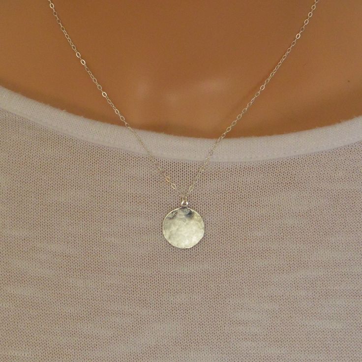 This beautiful simple sterling silver disc charm has been gently hammered to give it a beautiful sheen when the light hits it. It suspends from a sterling silver trace chain.  The disc charm measures 16 mm There is a choice of 14, 16, 18 or 20 inch sterling silver chain. A great everyday wear necklace  The necklace will arrive in a gift box so ready to give to a loved one. Sterling Silver Round Disc Delicate Jewelry, Sterling Silver Delicate Round Disc Jewelry, Delicate Sterling Silver Round Disc Jewelry, Everyday Hammered Round Disc Coin Necklace, Sterling Silver Round Disc Coin Pendant, Silver Engraved Dainty Coin Necklace, Sterling Silver Round Coin Necklace, Dainty Engraved Silver Coin Necklace, Delicate Hammered Sterling Silver Jewelry