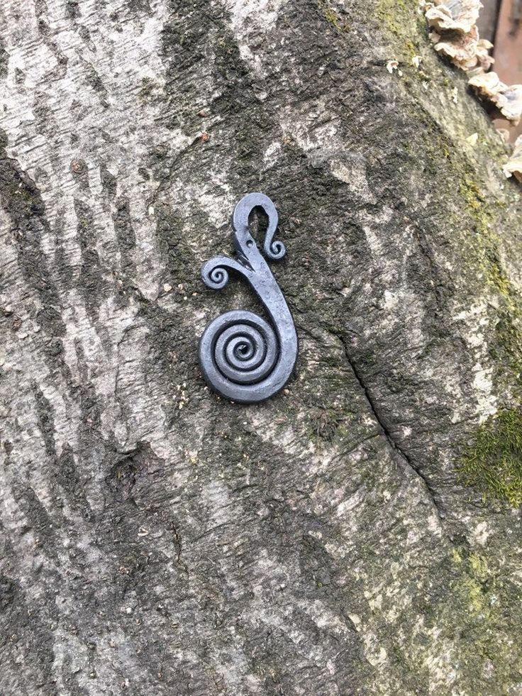 a metal object on the side of a rock