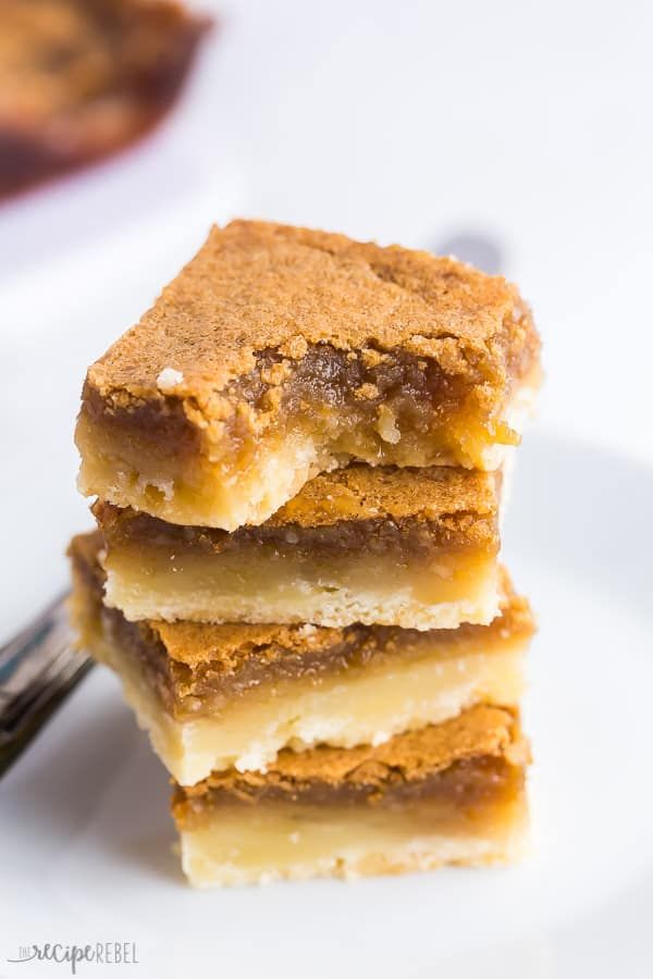 three pieces of dessert sitting on top of a white plate with a fork in front of it