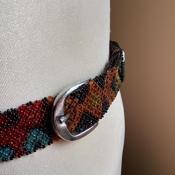 Vintage Native style seed bead adjustable belt indigenous style multi color ITEM DESCRIPTION: Offering this vintage multi-colour seed beed adjustable belt.  This hip belt features small plastic beads in varying patterns designed like a Native American accessory. MEASUREMENTS: This quality mod adjustable belt measures approximately 39 inches long (full length, including buckle) and 1 1/8 inches wide.  CONDITION: This belt is in good vintage condition. POLICIES: Please keep in mind, I am not an ex Native Weman Powwow Belts, Beaded Metis Sash, Indigenous Style, Vintage Retro Decor, Hip Belt, Wardrobe Accessories, Native Style, Beaded Belt, Plastic Beads