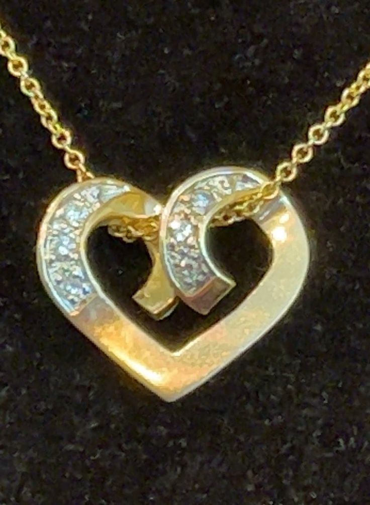 A dainty 14K solid yellow gold heart embraces six sparkly diamonds on a 14K yellow gold chain. The heart measures about 1 3/4 inches across and 5/8 of an inch long. The chain is 20" and stamped 14K and Italy. I do not enhance my photos, but I have to say, the photo does not do justice to the sparkliness of the diamonds.   A certified gemologist rated the diamonds H to I in color (near-colorless) and S12 in clarity (slight inclusions), and established the value of the piece. The heart is stamped 14K. What a romantic gift, either to a very dear friend--or to yourself, because you deserve it! Gold Diamond Necklace With Open Heart Charm, Formal Heart-shaped Yellow Gold Diamond Necklace, Gold Double Heart Diamond Cut Necklace, Gold Heart Cut Diamond Necklace For Formal Occasions, Gold Heart Diamond Necklace With Accents, Gold Heart Necklace With Diamond Accents, Gold Diamond Accented Heart-shaped Necklace, Gold Double Heart Diamond Necklace, Gold Heart-shaped Diamond Necklace With Accents