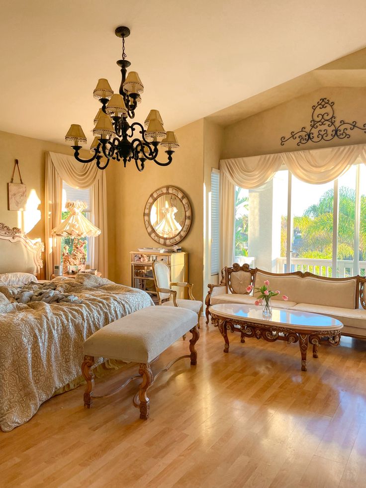 a bedroom with a large bed and chandelier