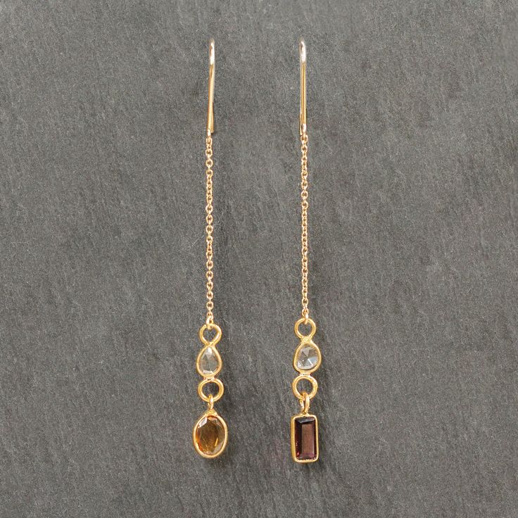 "These 18k Gold, Diamond, and Tourmaline Drop Chain Earrings are a one-of-a-kind, ethical addition to any jewelry collection.  Upcycled from vintage fine gold chains, these earrings feature 14k fishhooks at the top and channel set diamonds in 18k gold along the chain. The deep red and orange tourmaline gems, also set in 18k gold, add a pop of color to the earrings and hang elegantly as a drop. These earrings are the perfect combination of elegance and uniqueness, and can be worn with any outfit Luxury Gemstone Linear Earrings In Fine Jewelry Style, Beaded Jewelry Earrings, Red Tourmaline, Diamond Evil Eye, Tourmaline Earrings, Vintage Fine Jewelry, Red And Orange, Jewelry Lookbook, Hanging Earrings