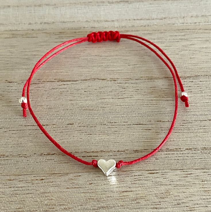 Silver Heart Adjustable Red Cord Bracelet, Gift for Her-Birthday, Anniversary, Christmas, Just because, Red Silver Jewellery, UK Shop Super gorgeous bracelet featuring a cute solid silver plated, nickel and lead free, heart on an adjustable red waxed cotton cord. This adorable bracelet makes a lovely gift for a special loved one. It is sure to put a smile on the recipient's face. The bracelet is 30 cm in length and securely tied with a comfortable sliding knot and is suitable to fit any size wri Adjustable Bracelets For Valentine's Day Party, Adjustable Red Heart Bracelet For Friendship, Adjustable Bracelet With Heart Charm For Party, Adjustable Party Bracelet With Heart Charm, Adjustable Red Heart Charm Bracelet, Adjustable Red Bracelet With Heart Charm, Adjustable Red Heart Bracelet For Valentine's Day, Adjustable Red Bracelets With Heart Charm, Red Heart Bracelet For Party