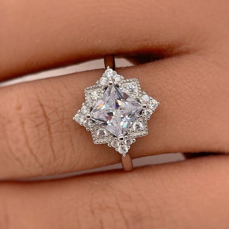 a woman's hand with a diamond ring on it