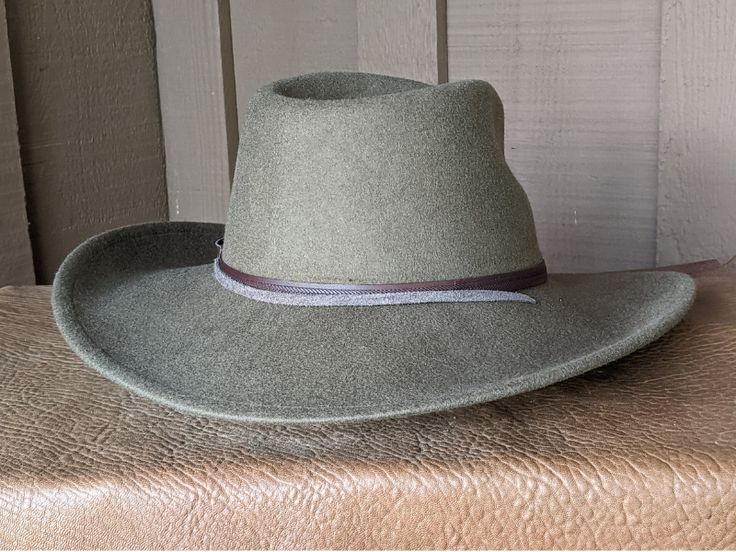 This 100% wool felt fedora is classically styled. Ready for your outdoor adventure! Perfect styling for a man or a woman. Simple leather hatband that is finished with a replicated Buffalo Nickel Concho. It has a stampede string to keep your hat on your head when the wind kicks up. Water resistant and crushable. The brim is 3.5" and the crown is 4.5" This hat ships within 2 - 3 days. Introduced in 1913, the Buffalo Nickel was an early hit with collectors and a major circulation workhorse through Native American Chief, Hat Holder, American Bison, Buffalo Nickel, Cloth Tape, Indian Chief, Felt Fedora, Simple Leather, Lewis And Clark