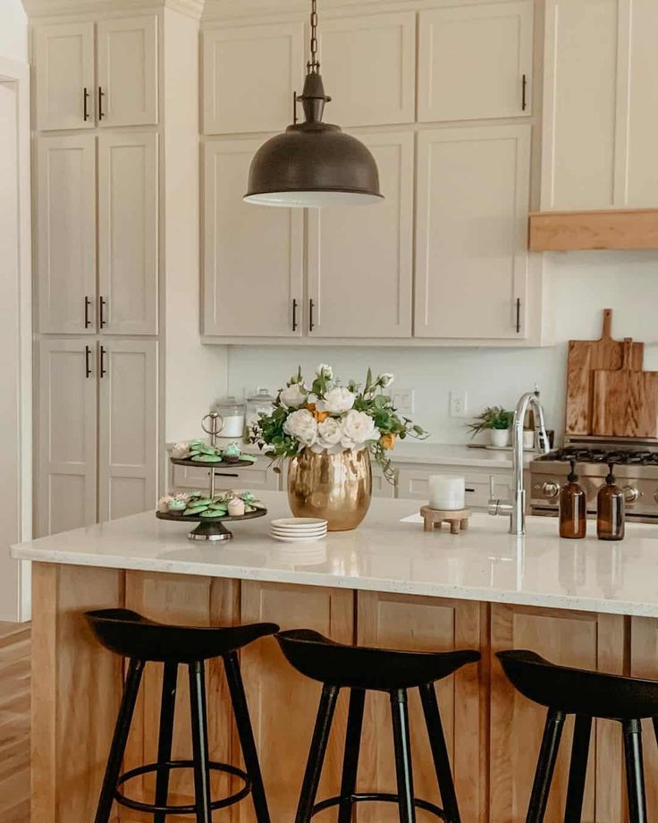 a kitchen with two stools and a center island