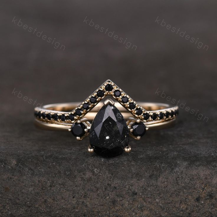 a black diamond ring on top of a rock