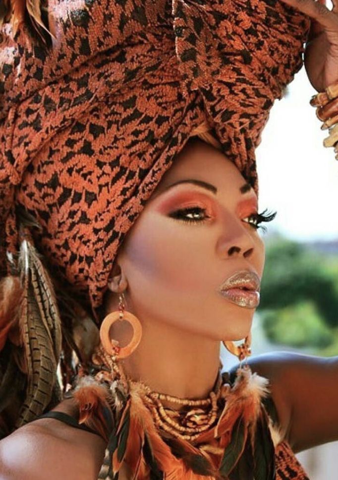 a woman wearing an elaborate headdress and jewelry