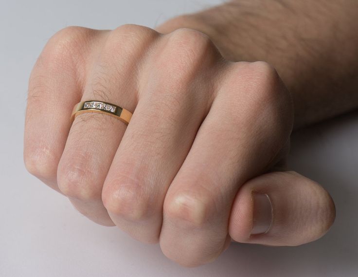 a man's hand with a ring on it that says love is in the air