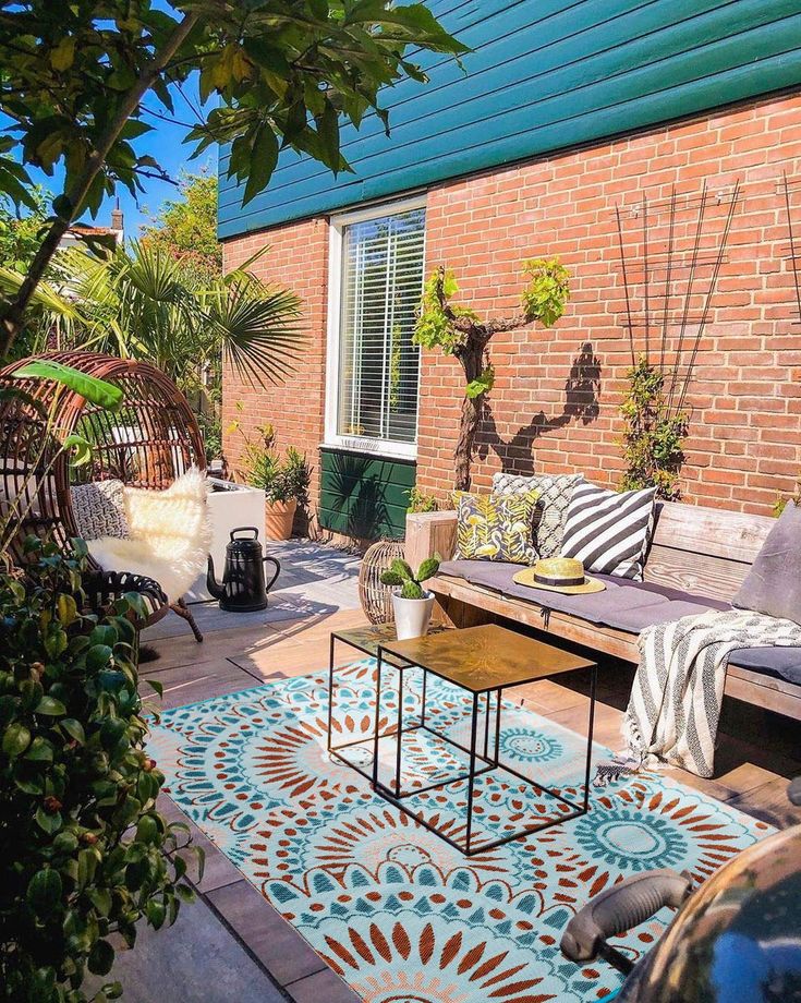 an outdoor patio with lots of seating and plants