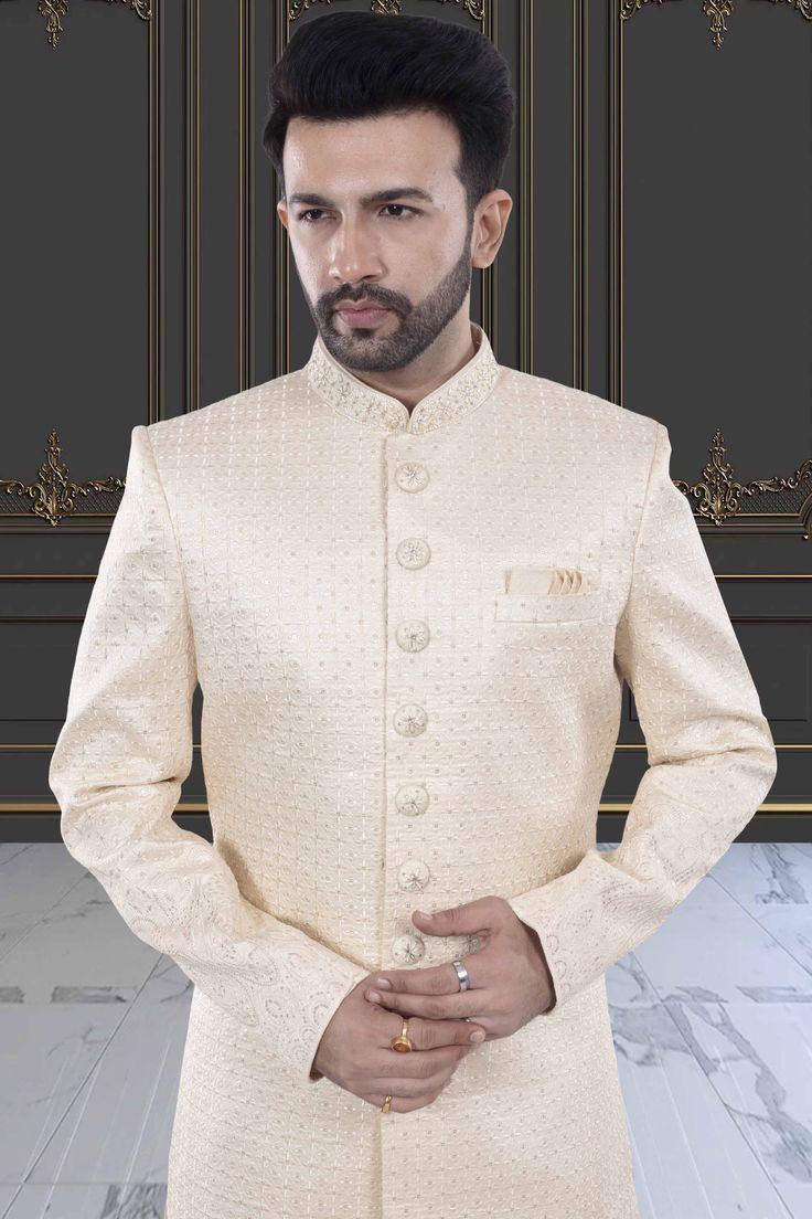 This men's sherwani (traditional Indian attire) features expertly crafted thread and sequin work. The intricate detailing adds a touch of elegance to any occasion. Made from high-quality materials, it offers both style and comfort. Perfect for those seeking a traditional yet sophisticated look. Elegant Cream Bandhgala With Chikankari Embroidery, Formal Cream Nehru Jacket With Chikankari Embroidery, Formal Beige Sherwani With Chikankari Embroidery, Elegant Beige Sherwani With Chikankari Embroidery, Elegant Traditional Style Kurta, Elegant Sherwani With Chikankari Embroidery For Diwali, Cream Chikankari Embroidered Sherwani For Formal Occasions, Elegant Cream Nehru Jacket With Chikankari Embroidery, Formal Cream Sherwani For Diwali