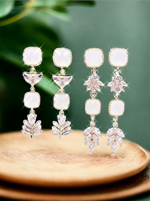 Glamorous White Cubic Zirconia Chandelier Earrings, Formal White Crystal Chandelier Earrings, White Crystal Chandelier Earrings For Formal Occasions, Formal White Cubic Zirconia Chandelier Earrings, White Cubic Zirconia Chandelier Earrings For Formal Events, White Cubic Zirconia Chandelier Earrings For Formal Occasions, Glamorous White Clip-on Earrings For Evening, Glamorous White Bridal Earrings With Elegant Design, Elegant White Chandelier Earrings For Anniversary