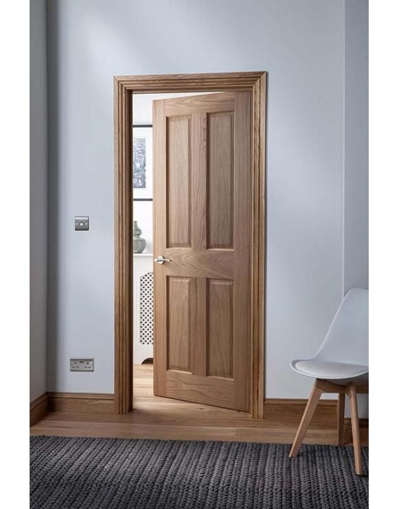 a white chair sitting in front of a wooden door