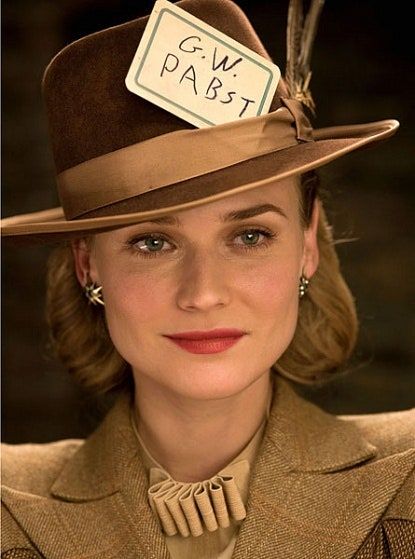 a woman wearing a brown hat with a tag on it