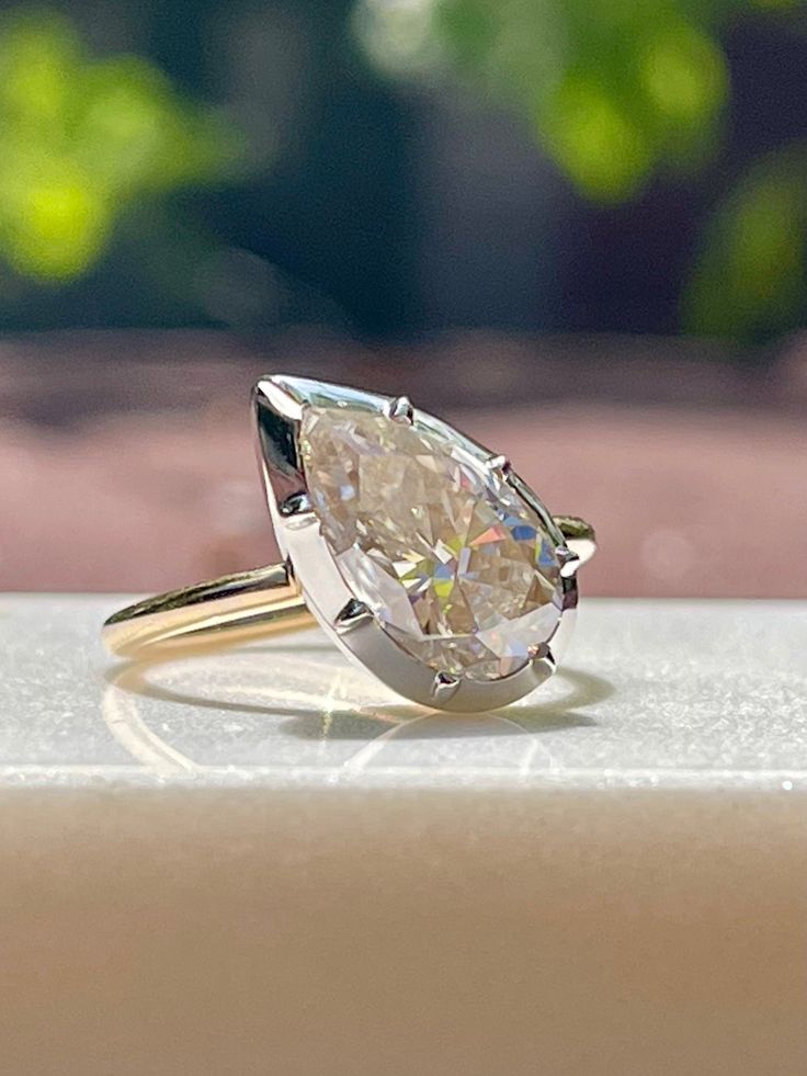 a close up of a diamond ring on a table