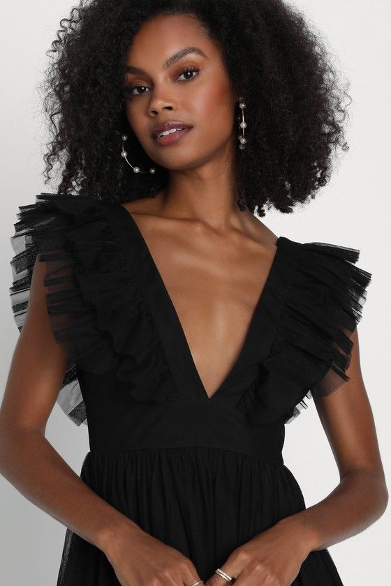 We can't wait for the perfect occasion to come around so we can stun everyone with the Lulus Simply Delighted Black Mesh Ruffled Backless Maxi Dress! This stunning dress is composed of sheer mesh fabric (atop a matching knit liner) that shapes wide straps adorned with flouncy ruffled trim, wide straps, and a sleeveless bodice with a sultry backless design. A high, banded waist tops a twirl-worthy, A-line skirt that cascades down to a sweeping maxi hem. Hidden back zipper/clasp. Fit: This garment Elegant V-neck Tulle Mini Dress, Fitted Tulle Maxi Dress For Night Out, Black V-neck Mesh Dress For Summer, Chic V-neck Mesh Dress For Evening, Spring V-neck Mesh Dress For Night Out, Flirty V-neck Maxi Dress For Evening, V-neck Evening Dress With Ruffles For Party, Glamorous Tulle Mini Dress For Party Season, Black Mesh Dress For Prom