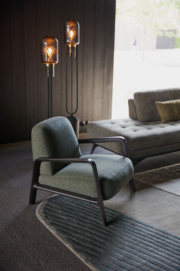 a living room with a couch, chair and floor lamp