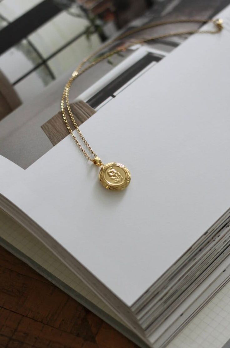 18-karat gold plated floral locket pendant hangs on a sturdy 18-karat gold plated stainless steel chain.  Choose your chain length from the drop-down menu.  SILVER version of this locket is also available. Click the link below to purchase. https://www.etsy.com/ca/listing/1612926901/silver-floral-locket-necklace-with?click_key=f4711079eaf4f5d7fb7c6694b5edeb992b0bbd97%3A1612926901&click_sum=5968e3ba&ref=shop_home_active_1&pro=1&frs=1 This locket is perfect for using as a keepsake necklace and is a thoughtful gift for someone special in your life. You can choose the locket as is, without photos, or have it personalized with your photo (s) and engrave either your initial, name, your birth flower, a special date or a message at the BACK or the locket. You choose your options at checkout. The pi Dainty Gold Plated Pendant Locket Necklace, Gold Plated Coin Pendant Jewelry Gift, Gold Locket Jewelry For Her, Dainty Gold-plated Locket Necklace, Gold Initial Pendant Amulet Jewelry, Gold Plated Tarnish Resistant Locket Necklace As Gift, Gold-tone Gold Plated Locket Necklace Gift, Dainty Gold Jewelry With Coin Pendant, Gold Plated Tarnish Resistant Locket Pendant Necklace