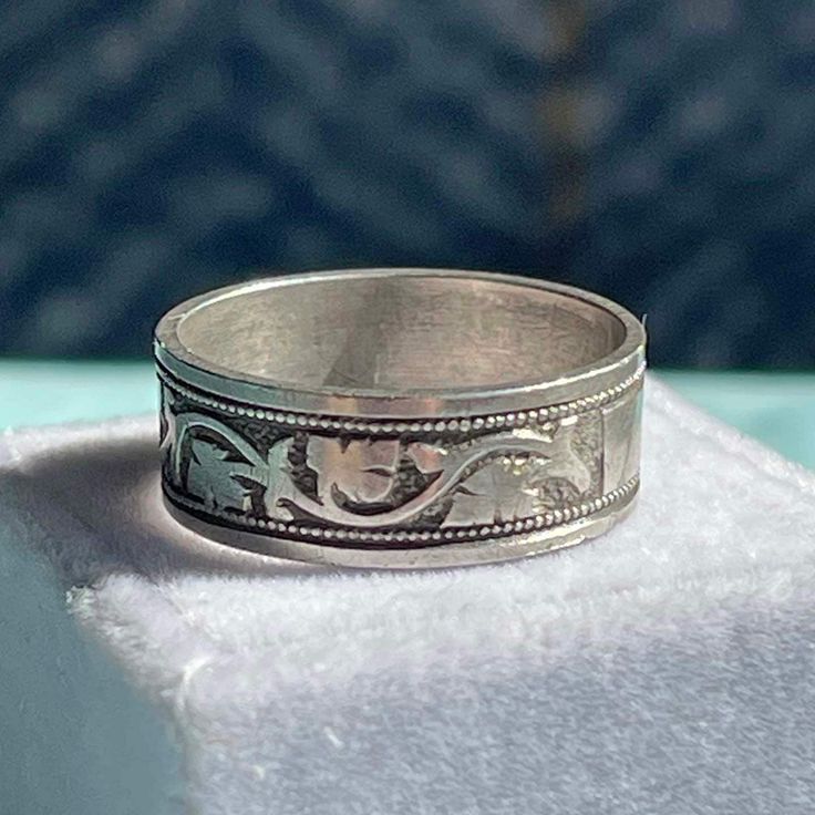 Step back into the elegance of Victorian England with this exquisite silver ring, crafted in Birmingham in 1881. Fully hallmarked, this piece is a testament to the craftsmanship and style of the era. The ring, measuring 7 mm north to south around the entire band, features a beautifully engraved pattern that captivates the eye. At its center lies a rectangular silver plaque, intended for an inscription that was never made, adding an air of mystery and possibility. Weighing 3.7 grams and sized at 7, this ring is not just jewelry but a connection to the past. Its timeless design and detailed engraving make it a unique addition to any collection, celebrating the elegance and craftsmanship of 19th-century England. I offer free layaway on most items purchased for full retail price, please inquir Heirloom White Gold Jewelry With Thick Band, Classic Engraved Rings For Ceremonial Occasion, Classic Engraved Rings For Ceremonies, Classic Ceremonial Engraved Rings, Heirloom Rings With Decorative Band, White Gold Jewelry With Decorative Wide Band, White Gold Wide Band With Decorative Details, Victorian Engraved Ring With Decorative Band For Anniversary, Classic White Gold Engraved Ceremonial Ring