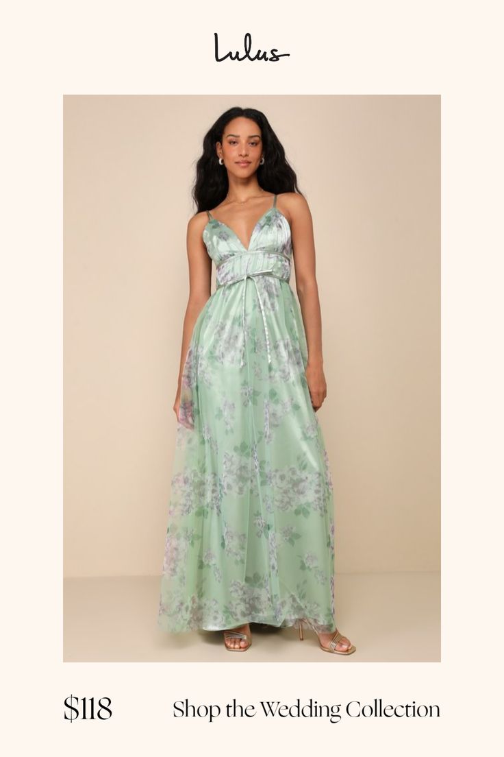 a woman in a long green dress with flowers on it and the words shop the wedding collection