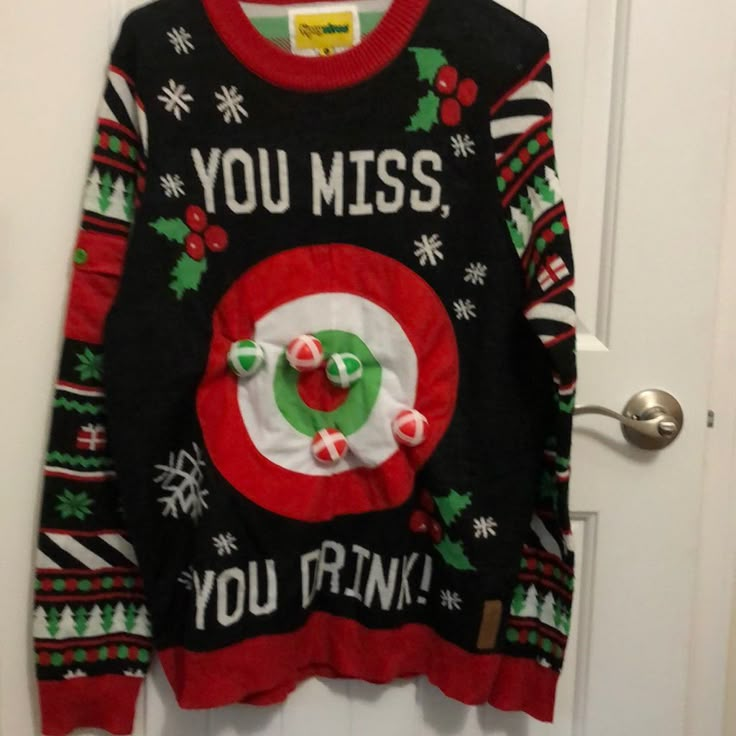 an ugly christmas sweater hanging on a door