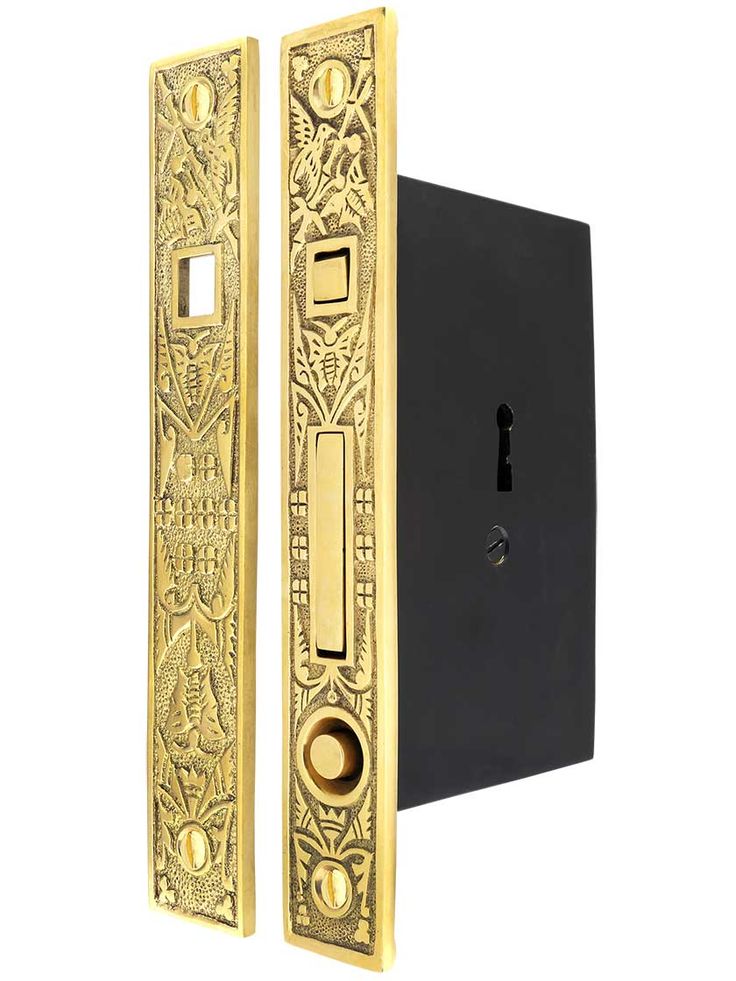 the door handle is gold and has an intricate design on it's front side