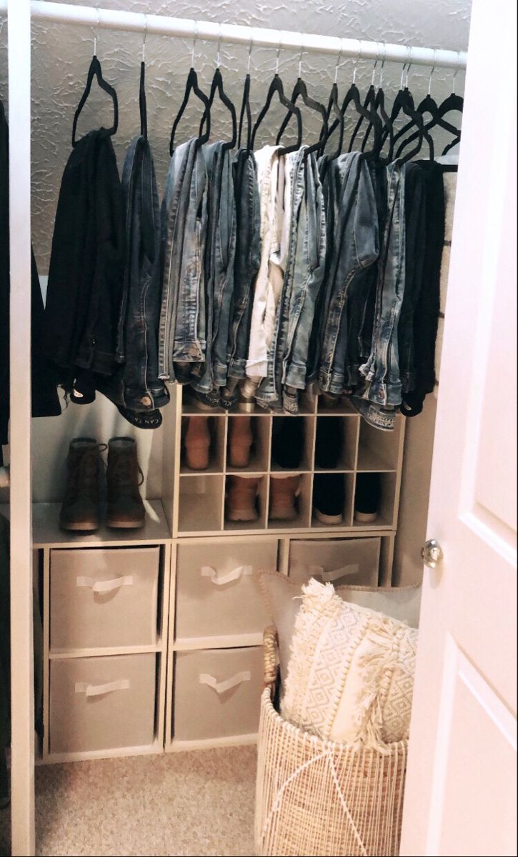 an organized closet with clothes and shoes