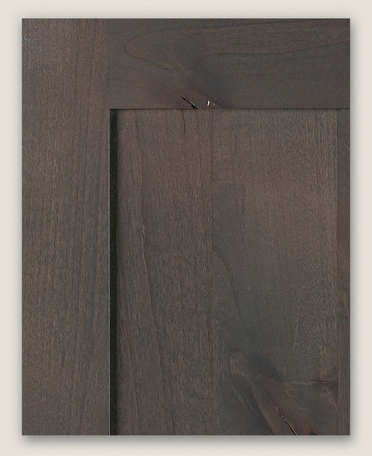 a close up view of the wood grains on this cabinet door, which has been painted dark brown