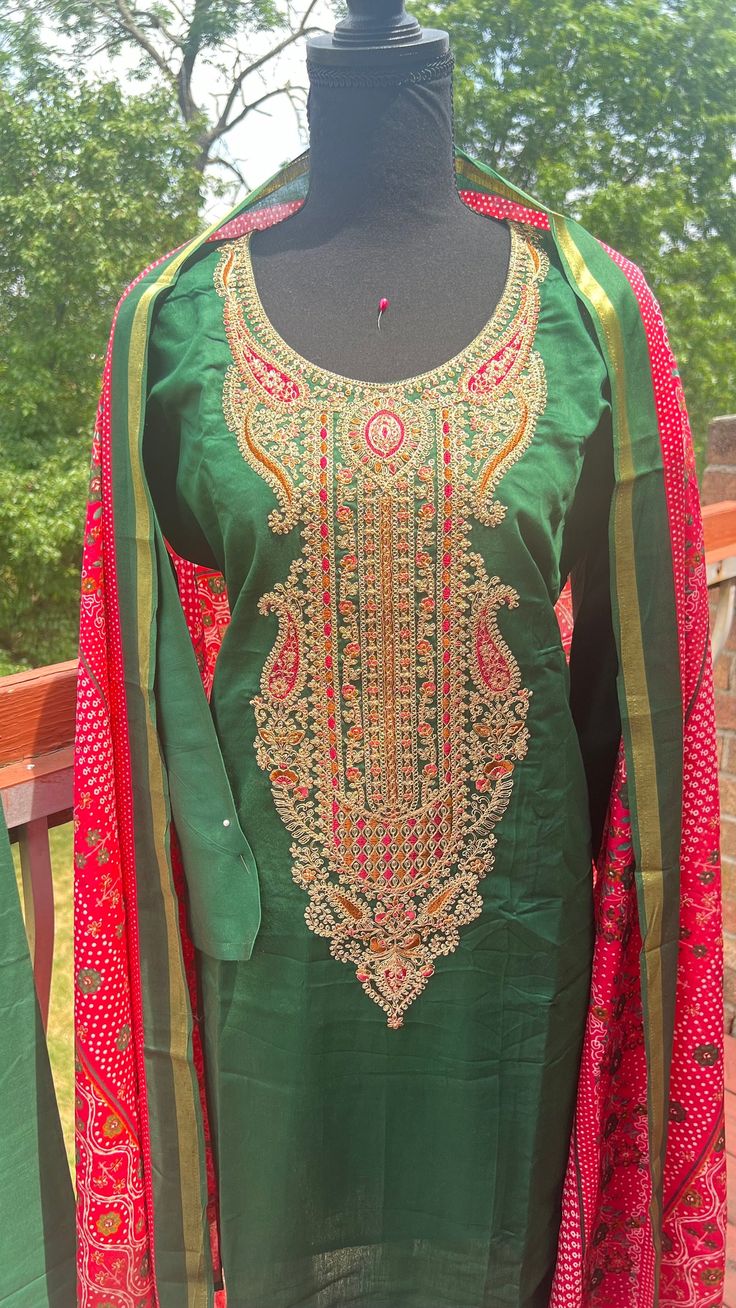 This suit is ready to wear. The size is Indian size XL or 42.  Brand: Mumtaz Dilreet JAM satin designer dress. Full Fabric Details: Top : Jam Satin Neck And Daman Embroidery work. Inner: The top has a cotton inner. Bottom: Cotton Dyed .pant style Dupatta: Lawn Mul Mul Pallu Digital Print. Pant length:39.5" Pant waist:44" Top length: 43" Top burst: 42" Sleeve length :18" Designer Cambric Dress For Festivals, Unstitched Cambric Dress With Dabka Work, Cambric Salwar Kameez For Wedding, Unstitched Silk Dress For Navratri, Festival Cambric Dress, Unstitched Cotton Silk Dresses For Designer Wear, Cotton Dress With Dabka Work For Eid, Fitted Cotton Silk Dresses For Eid, Elegant Cotton Salwar Kameez For Navratri