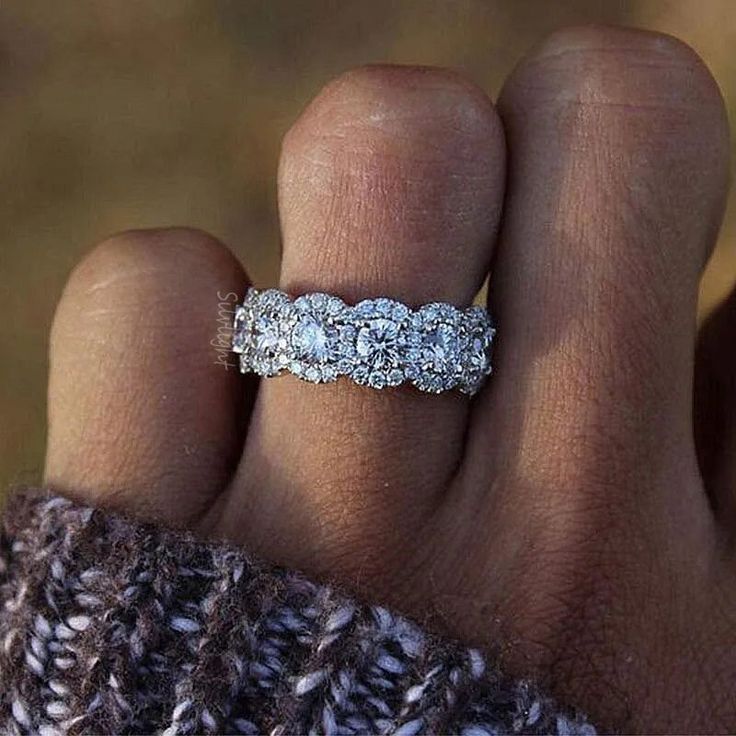 a woman's hand with a wedding ring on it